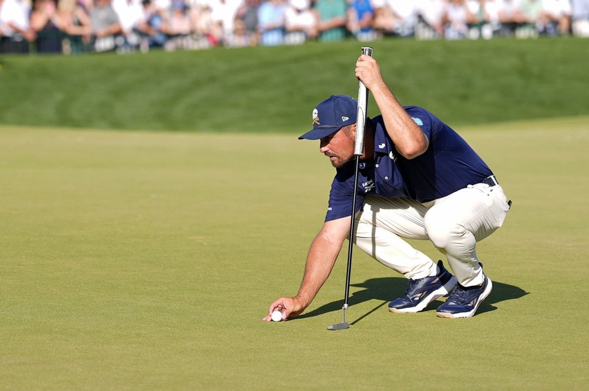 May 18, 2025; Charlotte, North Carolina, USA; Bryson DeChambeau lines up a putt on the 18th green during the final round of the PGA Championship golf tournament at Quail Hollow. Mandatory Credit: Jim Dedmon-Imagn Images