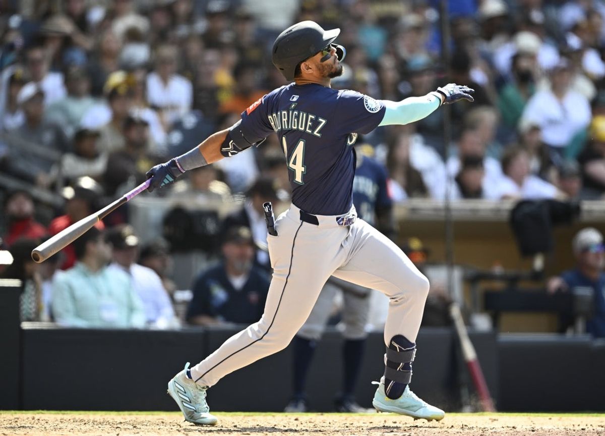 May 18, 2025; San Diego, California, USA; Seattle Mariners center fielder Julio Rodriguez (44) hits an RBI single during the ninth inning against the San Diego Padres at Petco Park. Mandatory Credit: Denis Poroy-Imagn Images