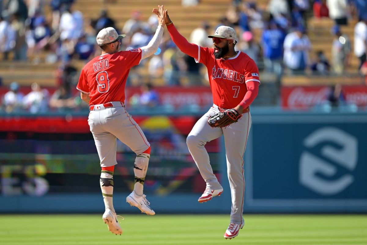 May 18, 2025; Los Angeles, California, USA;  Los Angeles Angels shortstop Zach Neto (9) and right fielder Jo Adell (7) celebrate after the final out of the ninth inning against the Los Angeles Dodgers at Dodger Stadium. Mandatory Credit: Jayne Kamin-Oncea-Imagn Images
