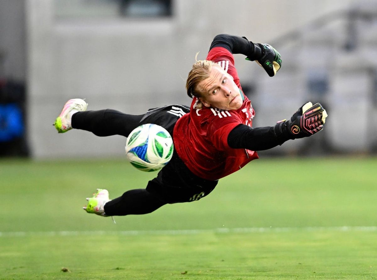 May 14, 2025; Los Angeles, California, USA;   Seattle Sounders goalkeeper Andrew Thomas (26) works on diving for the ball during warmups before a match against the Los Angeles FC at BMO Stadium. Mandatory Credit: Alex Gallardo-Imagn Images