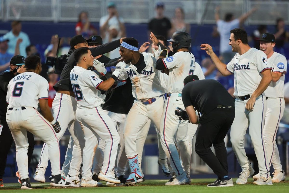 May 19, 2025; Miami, Florida, USA; Miami Marlins right fielder Jesus Sanchez (7) celebrates with teammates after hitting a walk-off triple against the Chicago Cubs at loanDepot Park. Mandatory Credit: Sam Navarro-Imagn Images