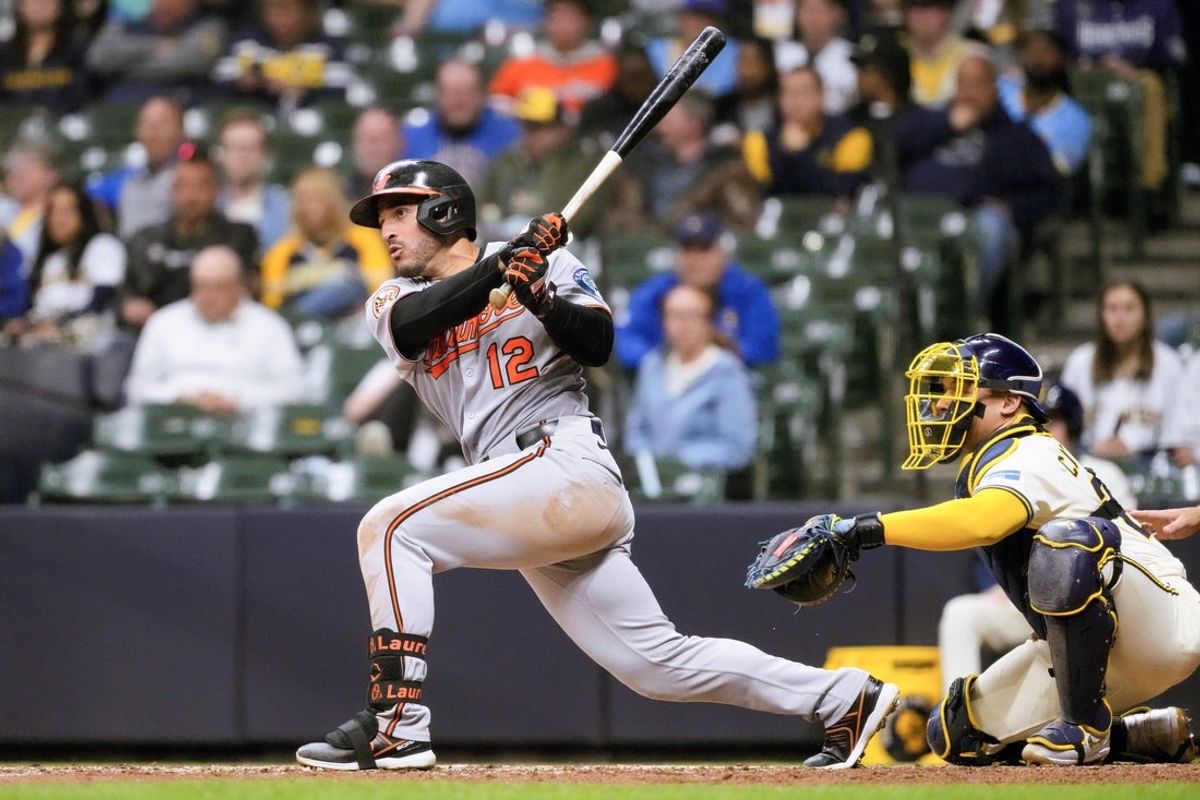 May 19, 2025; Milwaukee, Wisconsin, USA;  Baltimore Orioles right fielder Ramon Laureano (12) hits a single during the eighth inning against the Milwaukee Brewers at American Family Field. Mandatory Credit: Jeff Hanisch-Imagn Images