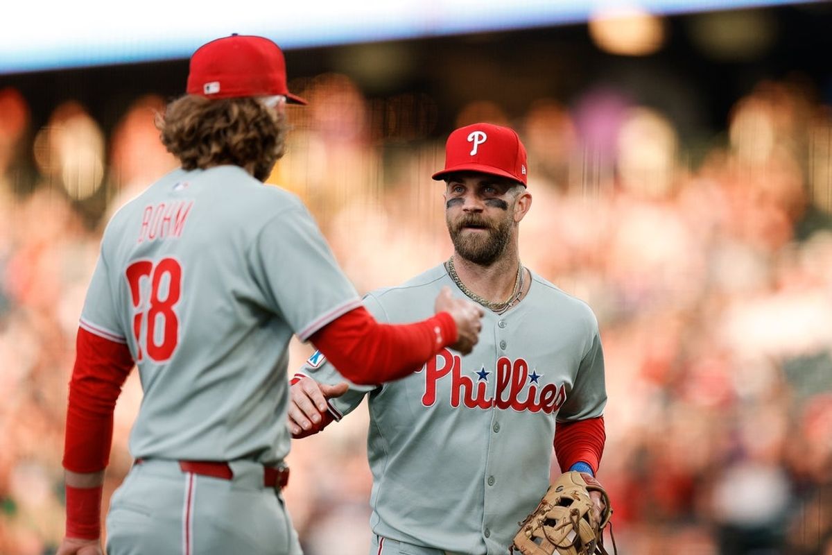 May 19, 2025; Denver, Colorado, USA; Philadelphia Phillies first baseman Bryce Harper (3) reacts with third baseman Alec Bohm (28) after a play in the fourth inning against the Colorado Rockies at Coors Field. Mandatory Credit: Isaiah J. Downing-Imagn Images