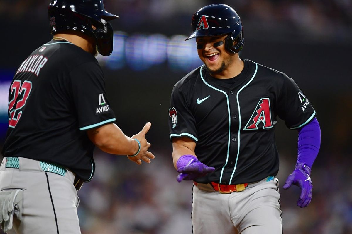 May 19, 2025; Los Angeles, California, USA;  Arizona Diamondbacks catcher Gabriel Moreno (14) celebrates with first baseman Josh Naylor (22) after hitting a two run home run in the third inning against the Los Angeles Dodgers at Dodger Stadium. Mandatory Credit: Gary A. Vasquez-Imagn Images