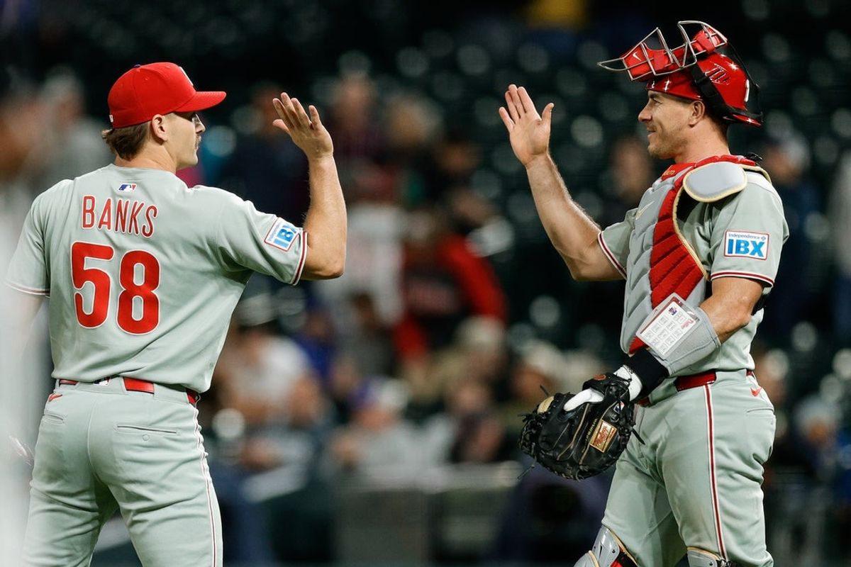 May 19, 2025; Denver, Colorado, USA; Philadelphia Phillies pitcher Tanner Banks (58) reacts with catcher J.T. Realmuto (10) after the game against the Colorado Rockies at Coors Field. Mandatory Credit: Isaiah J. Downing-Imagn Images