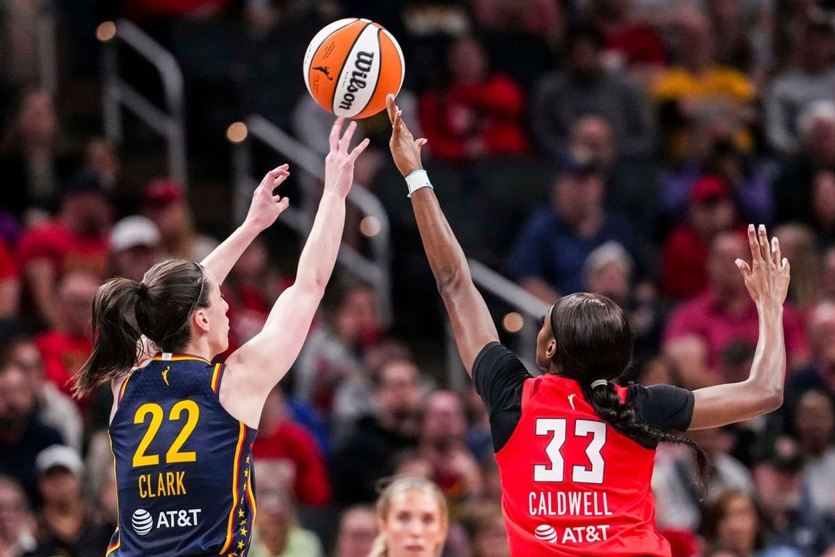 Indiana Fever guard Caitlin Clark (22) attempts a 3-pointer against Atlanta Dream guard Maya Caldwell (33) on Tuesday, May 20, 2025, during a game between the Indiana Fever and the Atlanta Dream at Gainbridge Fieldhouse in Indianapolis.
