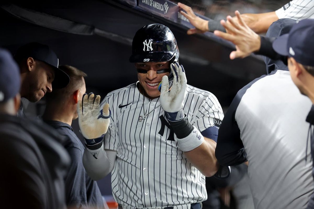 May 20, 2025; Bronx, New York, USA; New York Yankees right fielder Aaron Judge (99) celebrates his two run home run against the Texas Rangers with teammates in the dugout during the eighth inning at Yankee Stadium. Mandatory Credit: Brad Penner-Imagn Images