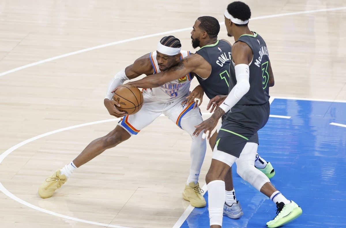 May 20, 2025; Oklahoma City, Oklahoma, USA; Oklahoma City Thunder guard Shai Gilgeous-Alexander (2) dribbles against Minnesota Timberwolves guard Mike Conley (10) and forward Jaden McDaniels (3) in the first quarter during game one of the western conference finals for the 2025 NBA Playoffs at Paycom Center. Mandatory Credit: Alonzo Adams-Imagn Images