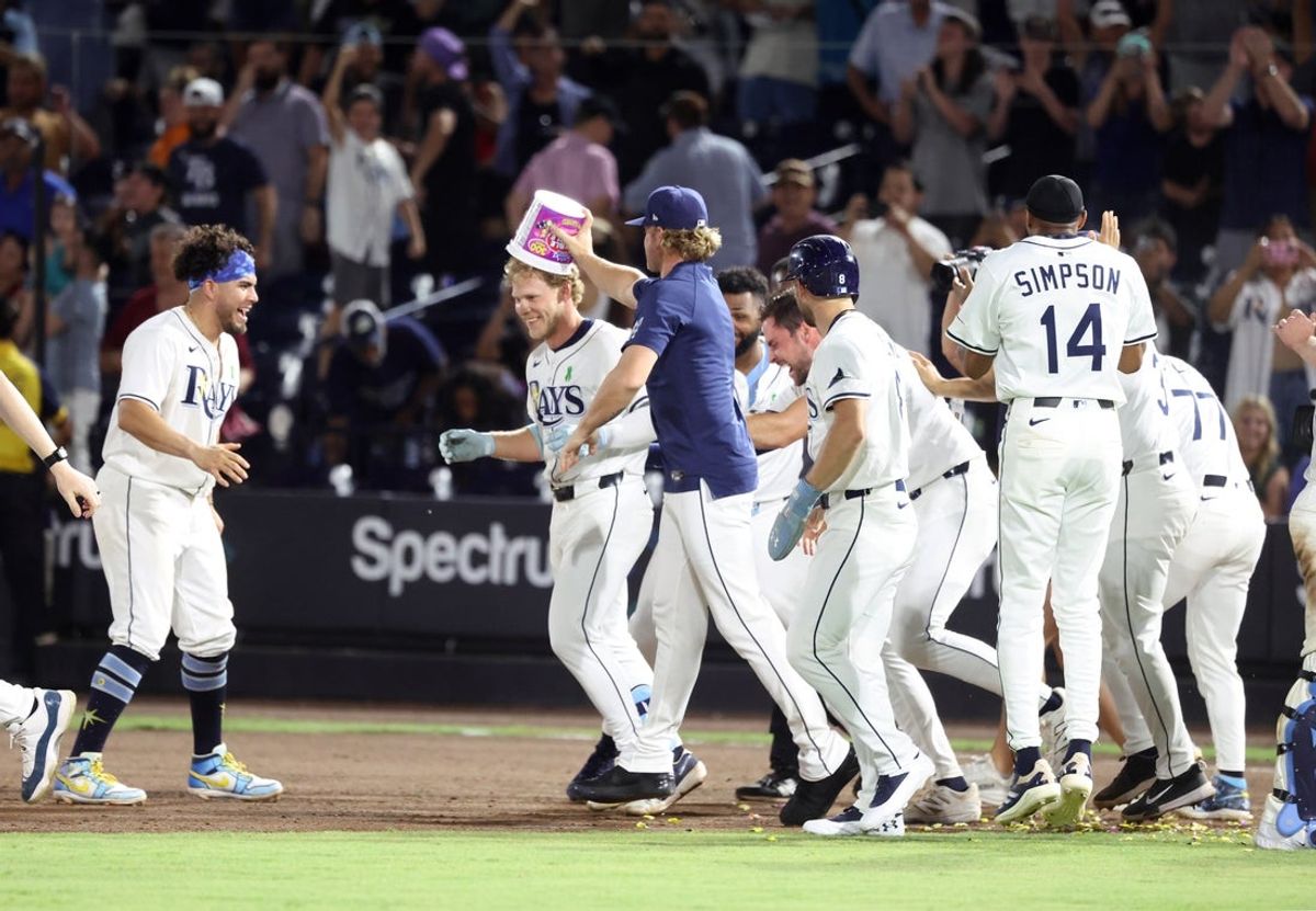 May 20, 2025; St. Petersburg, Florida, USA; Tampa Bay Rays shortstop Taylor Walls (6) is congratulated by teammates after he hit a walk-off RBI sacrifice fly to beat the Houston Astros at George M. Steinbrenner Field. Mandatory Credit: Kim Klement Neitzel-Imagn Images