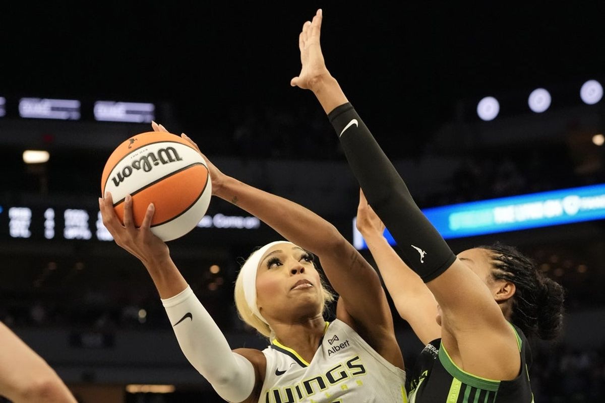 May 21, 2025; Minneapolis, Minnesota, USA; Dallas Wings guard DiJonai Carrington (21) shoots against Minnesota Lynx forward Napheesa Collier (24) in the first quarter at Target Center. Mandatory Credit: Bruce Kluckhohn-Imagn Images