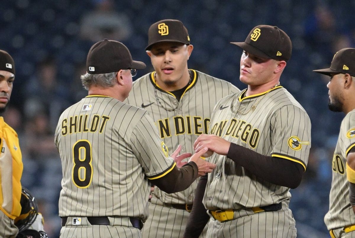 May 21, 2025; Toronto, Ontario, CAN;  San Diego Padres manager Mike Shildt (8) relieves pitcher Adrian Morejon (50) in the seventh inning against the Toronto Blue Jays at Rogers Centre. Mandatory Credit: Dan Hamilton-Imagn Images