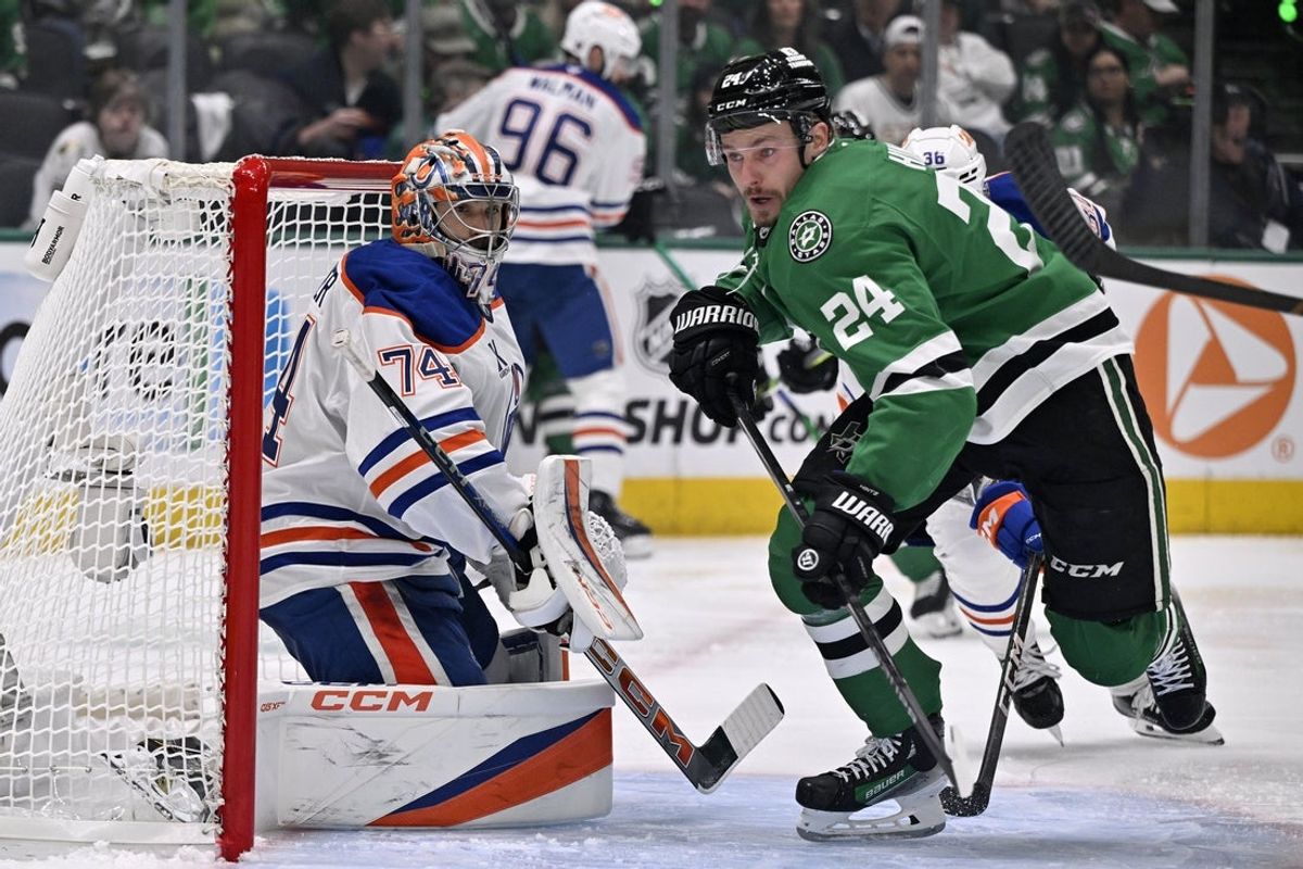 May 21, 2025; Dallas, Texas, USA; Dallas Stars center Roope Hintz (24) skates for a loose puck in front of Edmonton Oilers goaltender Stuart Skinner (74) in the second period during game one of the Western Conference Final of the 2025 Stanley Cup Playoffs at American Airlines Center. Mandatory Credit: Jerome Miron-Imagn Images