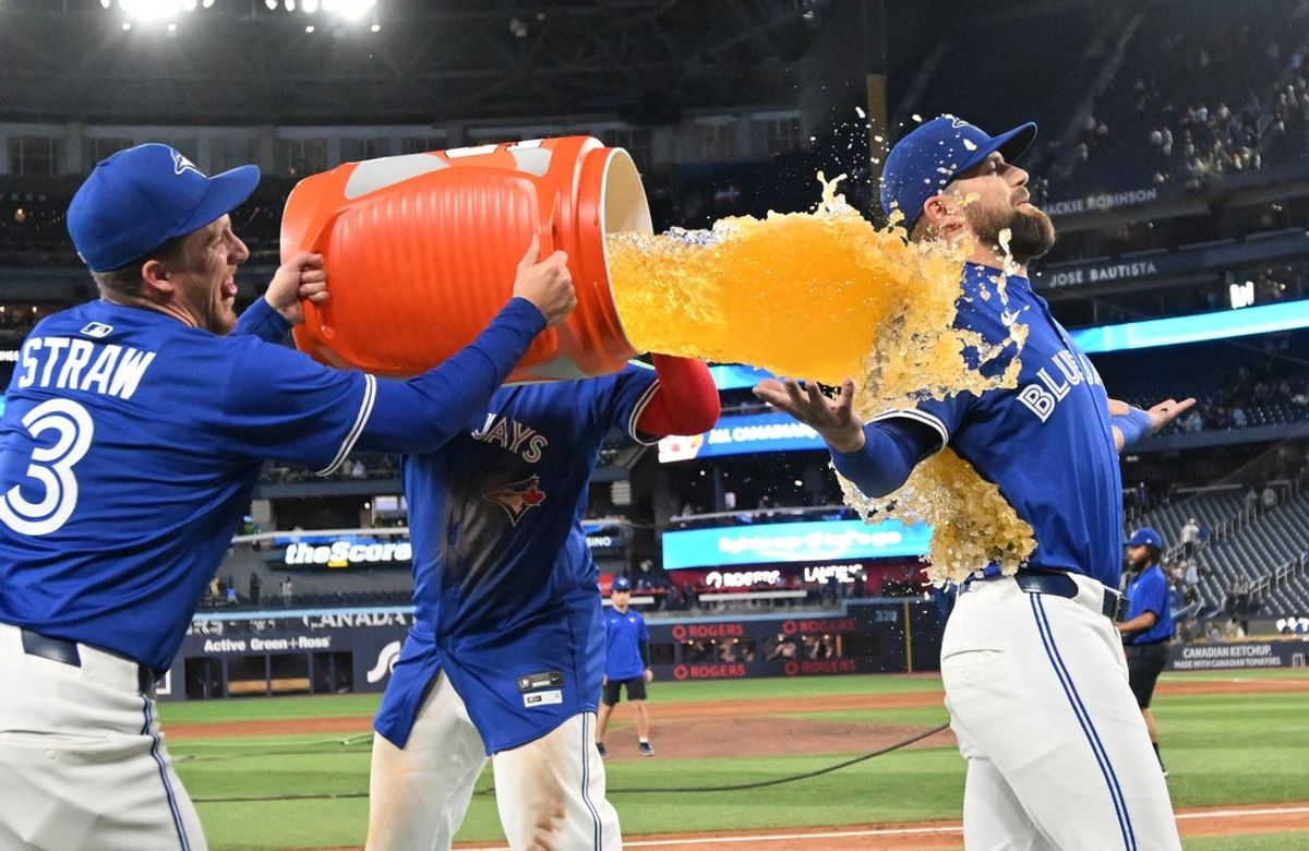 May 21, 2025; Toronto, Ontario, CAN;  Toronto Blue Jays left fielder Nathan Lukes (38) is doused with sport drink after a win over the San Diego Padres at Rogers Centre. Mandatory Credit: Dan Hamilton-Imagn Images