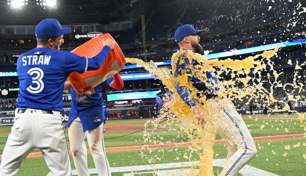 May 21, 2025; Toronto, Ontario, CAN;  Toronto Blue Jays left fielder Nathan Lukes (38) is doused with sport drink after a win over the San Diego Padres at Rogers Centre. Mandatory Credit: Dan Hamilton-Imagn Images