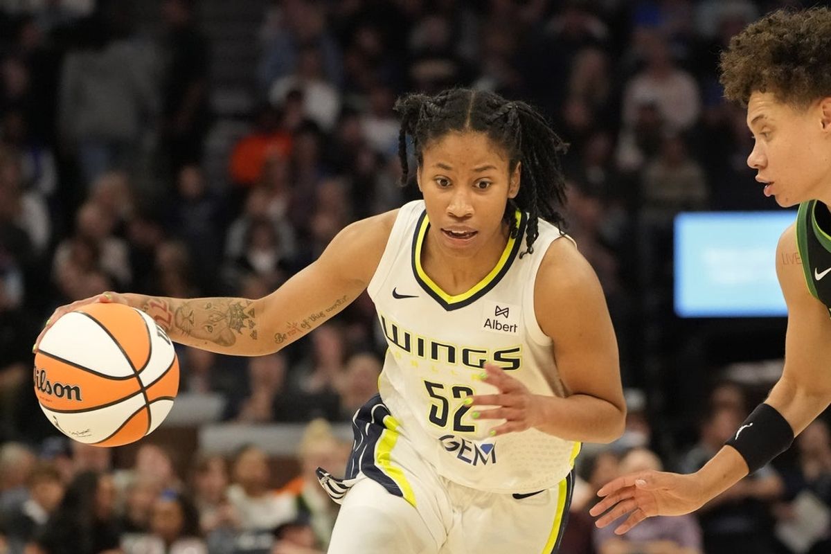 May 21, 2025; Minneapolis, Minnesota, USA; Dallas Wings guard Tyasha Harris (52) drives to the basket against Minnesota Lynx guard Natisha Hiedeman (2) in the second quarter at Target Center. Mandatory Credit: Bruce Kluckhohn-Imagn Images