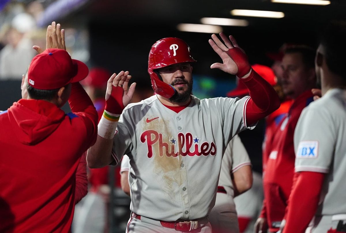 May 21, 2025; Denver, Colorado, USA; Philadelphia Phillies designated hitter Kyle Schwarber (12) celebrates scoring a run in the sixth inning against the Colorado Rockies at Coors Field. Mandatory Credit: Ron Chenoy-Imagn Images