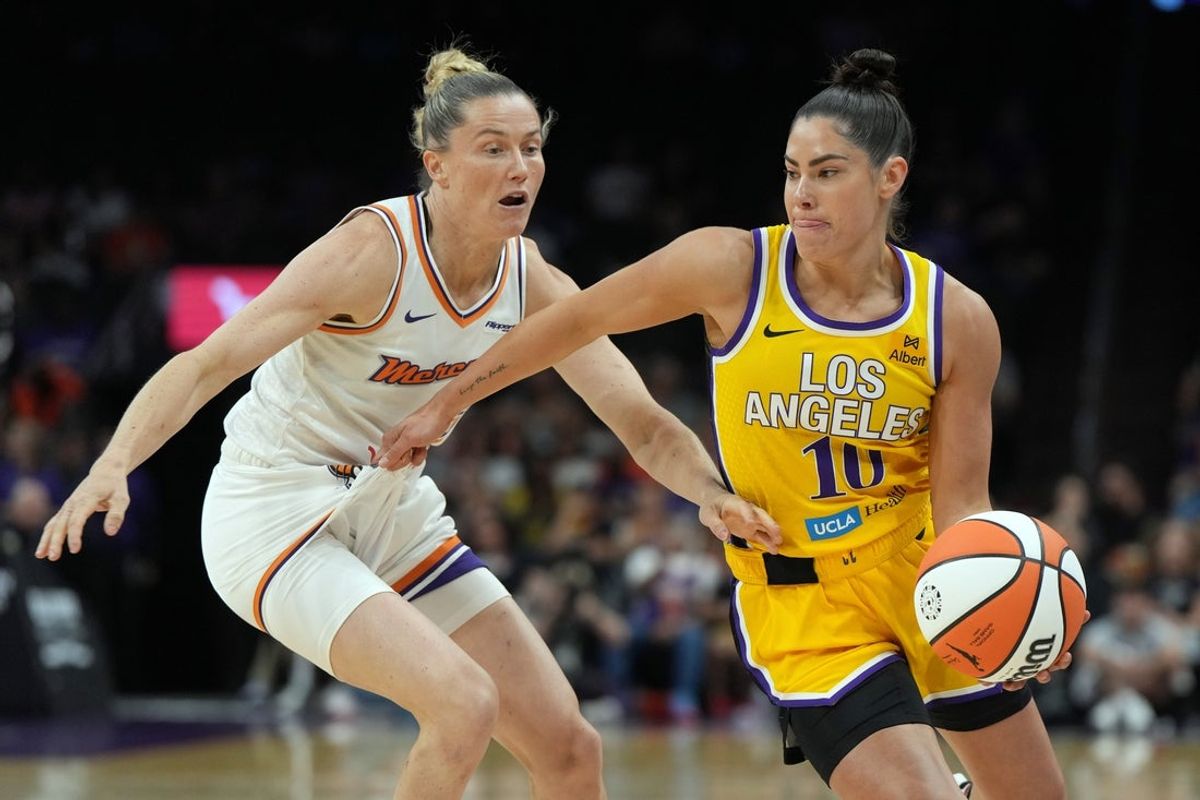 May 21, 2025; Phoenix, Arizona, USA; Los Angeles Sparks guard Kelsey Plum (10) drives past Phoenix Mercury guard Sami Whitcomb (33) in the first half at Footprint Center. Mandatory Credit: Rick Scuteri-Imagn Images