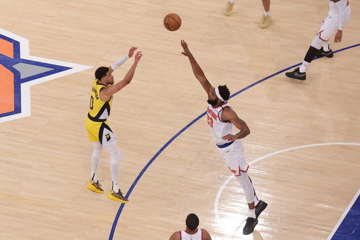 May 21, 2025; New York, New York, USA; Indiana Pacers guard Tyrese Haliburton (0) shoots a game-tying two point shot to send the game to overtime in the fourth quarter against New York Knicks center Mitchell Robinson (23) during game one of the eastern conference finals for the 2025 NBA Playoffs at Madison Square Garden. Mandatory Credit: Brad Penner-Imagn Images