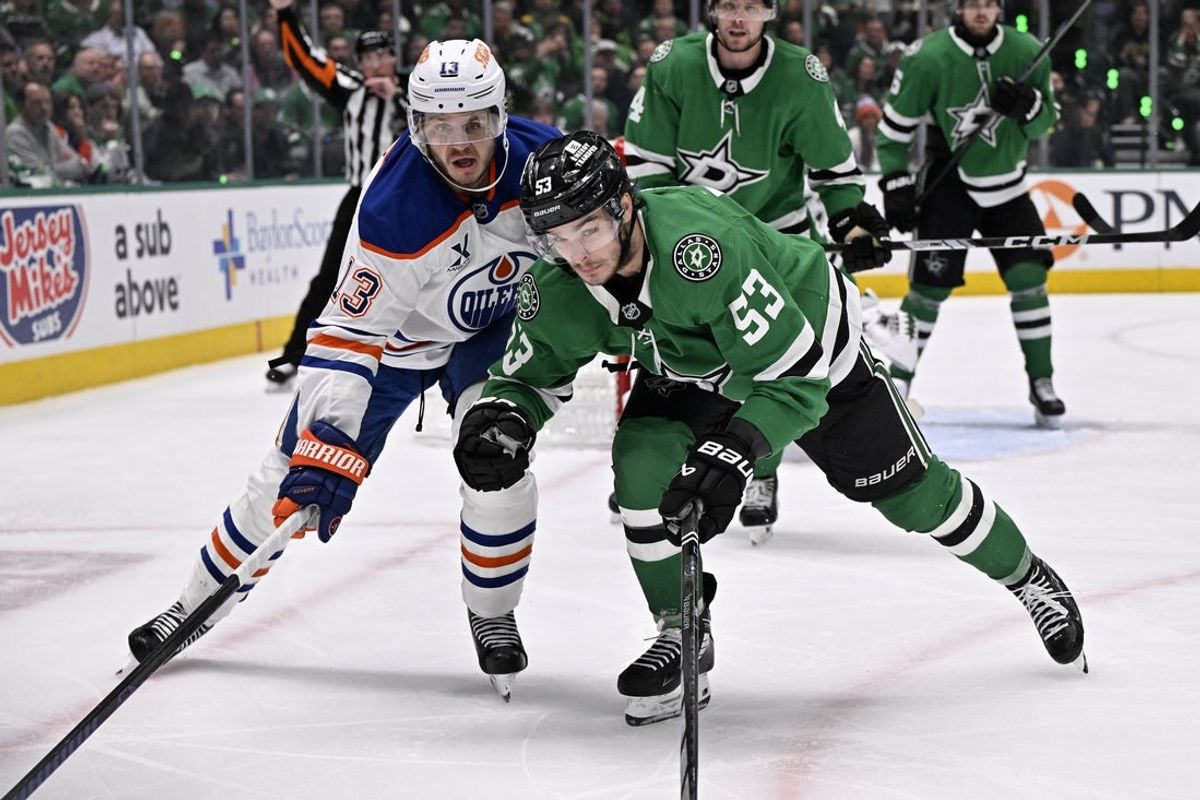 May 21, 2025; Dallas, Texas, USA; Dallas Stars center Wyatt Johnston (53) and Edmonton Oilers center Mattias Janmark (13) skate for a loose puck in the third period during game one of the Western Conference Final of the 2025 Stanley Cup Playoffs at American Airlines Center. Mandatory Credit: Jerome Miron-Imagn Images
