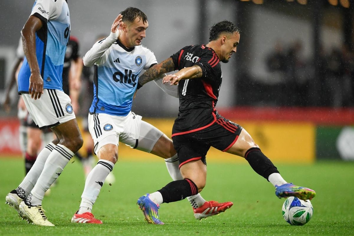 May 21, 2025; Washington, District of Columbia, USA; D.C. United forward Joao Peglow (7) controls the ball against Charlotte FC midfielder Nick Scardina (35) during the first half of the game at Audi Field. Mandatory Credit: Hannah Foslien-Imagn Images