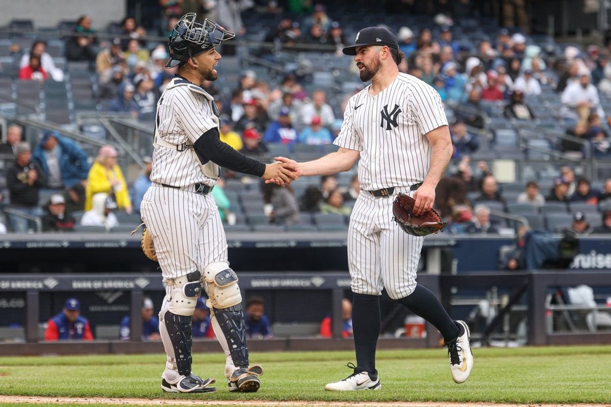 May 22, 2025; Bronx, New York, USA; New York Yankees starting pitcher Carlos Rodon (55) slaps hands with catcher J.C. Escarra (25)after the top of the sixth inning against the Texas Rangers at Yankee Stadium. Mandatory Credit: Vincent Carchietta-Imagn Images
