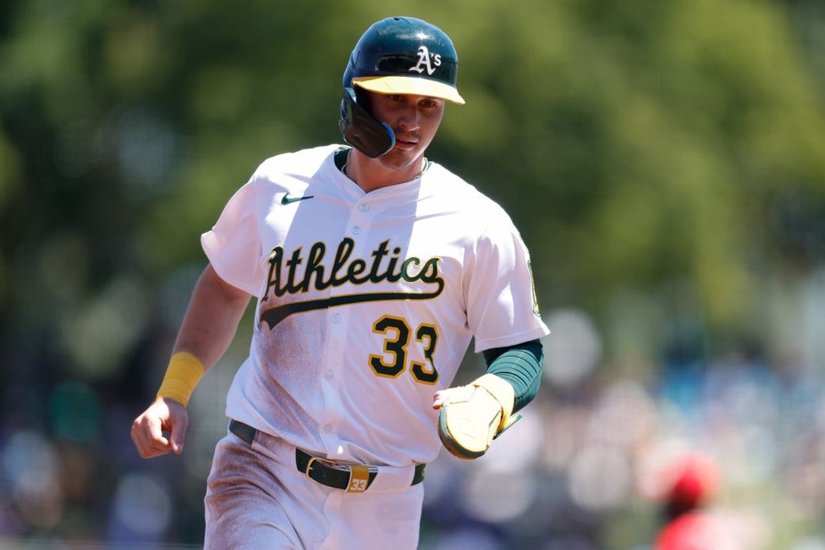 May 22, 2025; West Sacramento, California, USA; Athletics center fielder JJ Bleday (33) advances to third on a failed pick off attempt by Los Angeles Angels starting pitcher Tyler Anderson (31) during the third inning at Sutter Health Park. Mandatory Credit: Sergio Estrada-Imagn Images