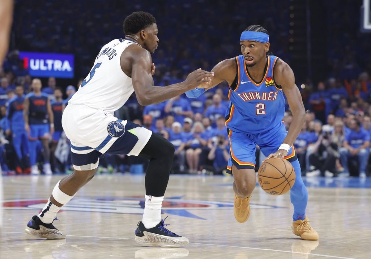 May 22, 2025; Oklahoma City, Oklahoma, USA; Oklahoma City Thunder guard Shai Gilgeous-Alexander (2) drives against Minnesota Timberwolves guard Anthony Edwards (5) in the first quarter during game two of the western conference finals for the 2025 NBA Playoffs at Paycom Center. Mandatory Credit: Alonzo Adams-Imagn Images