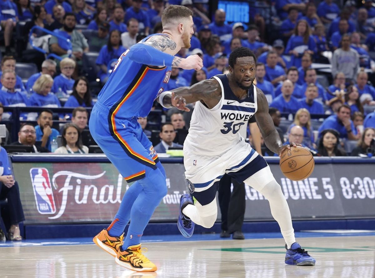 May 22, 2025; Oklahoma City, Oklahoma, USA; Minnesota Timberwolves forward Julius Randle (30) drives against Oklahoma City Thunder center Isaiah Hartenstein (55) in the third quarter during game two of the western conference finals for the 2025 NBA Playoffs at Paycom Center. Mandatory Credit: Alonzo Adams-Imagn Images