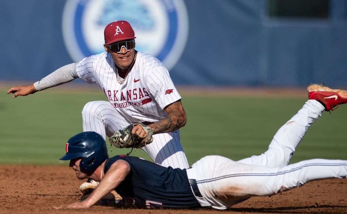 Arkansas Razorbacks' Wehiwa Aloy (9) tags out Ole Miss Rebels' Judd Utermark (27) at second base as Arkansas Razorbacks take on Ole Miss Rebels during the SEC baseball tournament at Hoover Met in Birmingham, Ala., on Friday, May 23, 2025. Ole Miss Rebels defeated Arkansas Razorbacks 5-2.