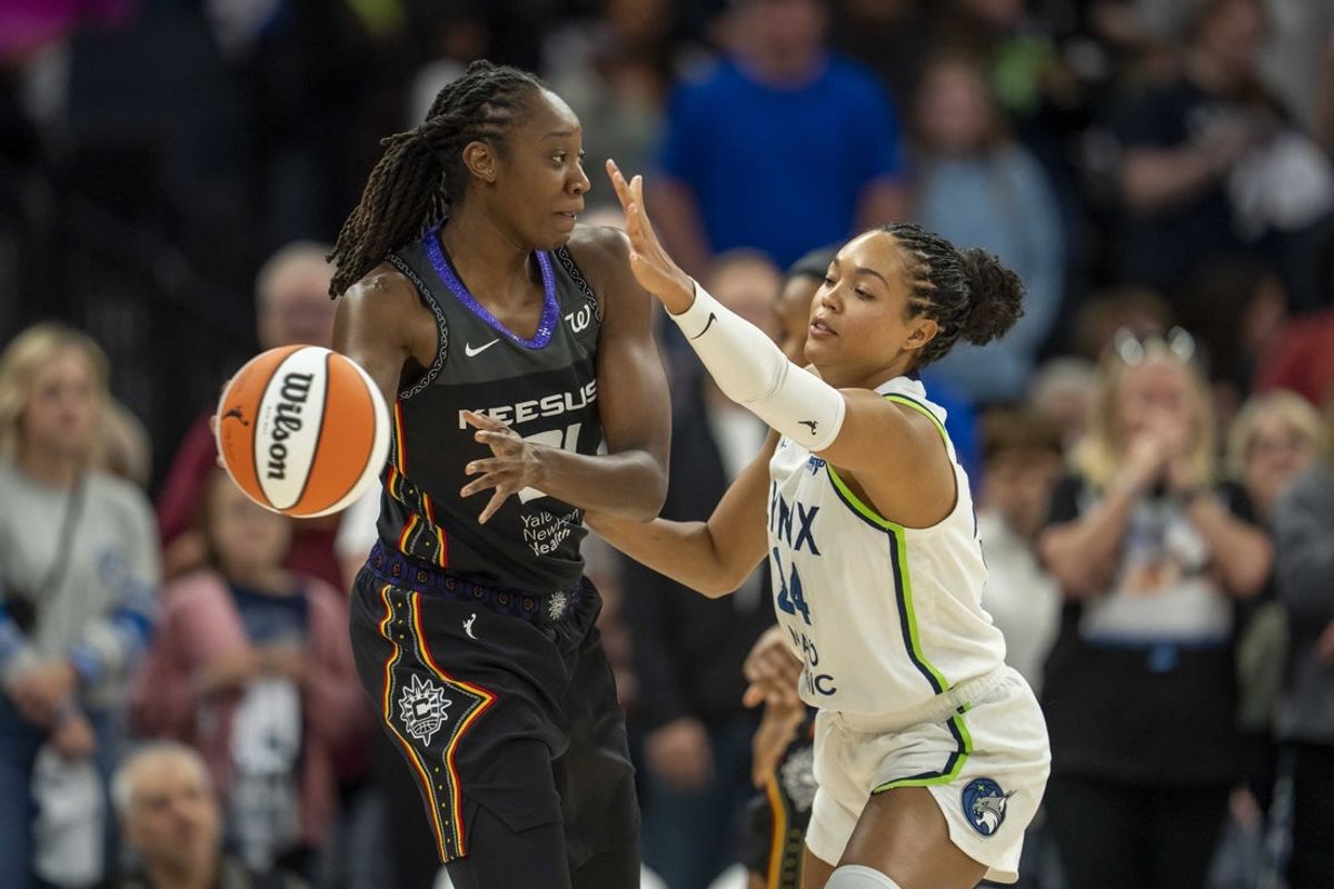 May 23, 2025; Minneapolis, Minnesota, USA; Connecticut Sun center Tina Charles (31) holds the ball as Minnesota Lynx forward Napheesa Collier (24) plays defense in the first half at Target Center. Mandatory Credit: Jesse Johnson-Imagn Images