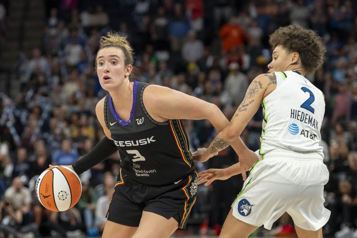 May 23, 2025; Minneapolis, Minnesota, USA; Connecticut Sun guard Marina Mabrey (3) dribbles the ball around Minnesota Lynx guard Natisha Hiedeman (2) in the second half at Target Center. Mandatory Credit: Jesse Johnson-Imagn Images