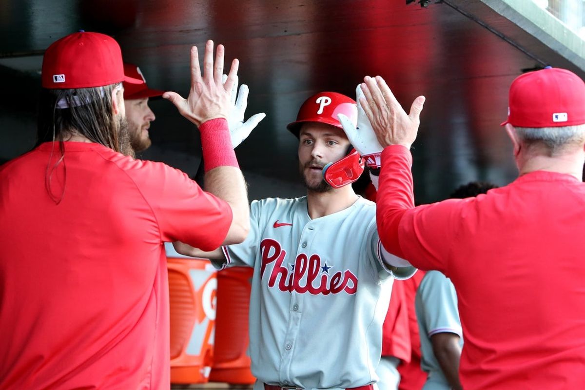 May 23, 2025; West Sacramento, California, USA;  Philadelphia Phillies shortstop Trea Turner (7) is congratulated by teammates in the dugout after hitting a solo home run against the Athletics during the first inning at Sutter Health Park. Mandatory Credit: Dennis Lee-Imagn Images