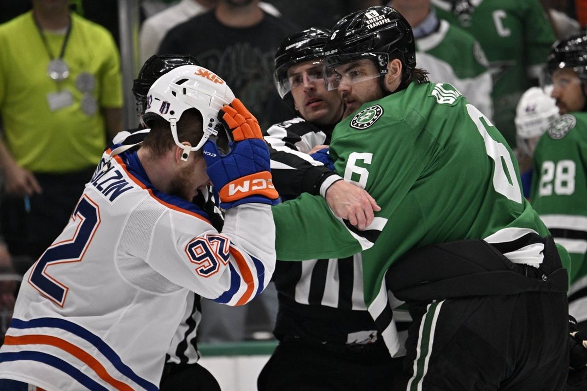 May 23, 2025; Dallas, Texas, USA; Edmonton Oilers right wing Vasily Podkolzin (92) and Dallas Stars defenseman Lian Bichsel (6) fight in the third period for game two of the Western Conference Final of the 2025 Stanley Cup Playoffs at American Airlines Center. Mandatory Credit: Jerome Miron-Imagn Images