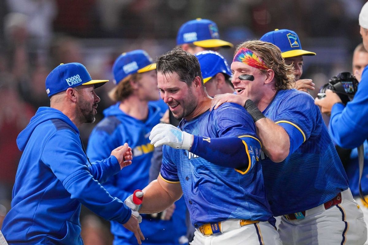 May 23, 2025; Minneapolis, Minnesota, USA; Minnesota Twins outfielder Harrison Bader (12) hugs first base Ty France (13) after his walk off home run against the Kansas City Royals in the ninth inning at Target Field. Mandatory Credit: Brad Rempel-Imagn Images