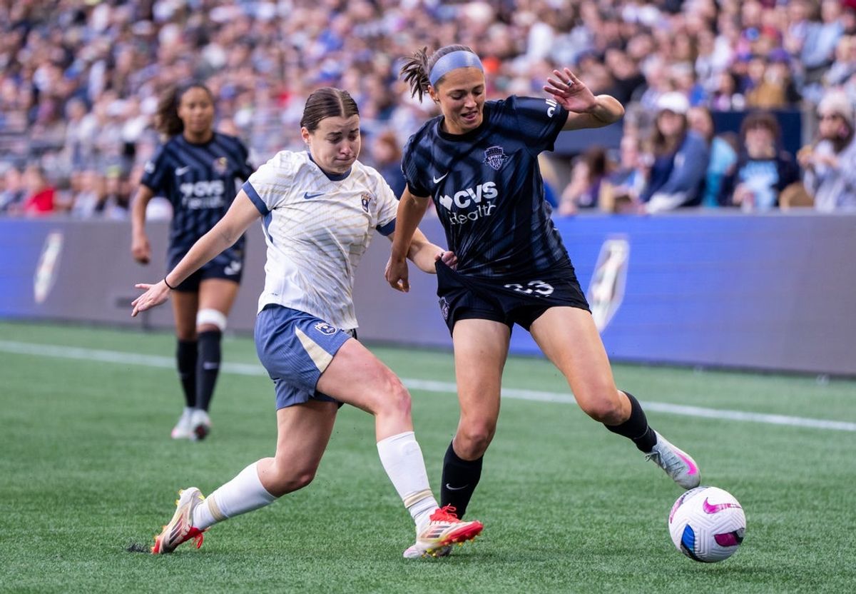 May 23, 2025; Seattle, Washington, USA;  Seattle Reign FC midfielder Angharad James-Turner (8) battles Washington Spirit forward Ashley Hatch (33) for the ball during the first half at Lumen Field. Mandatory Credit: Stephen Brashear-Imagn Images