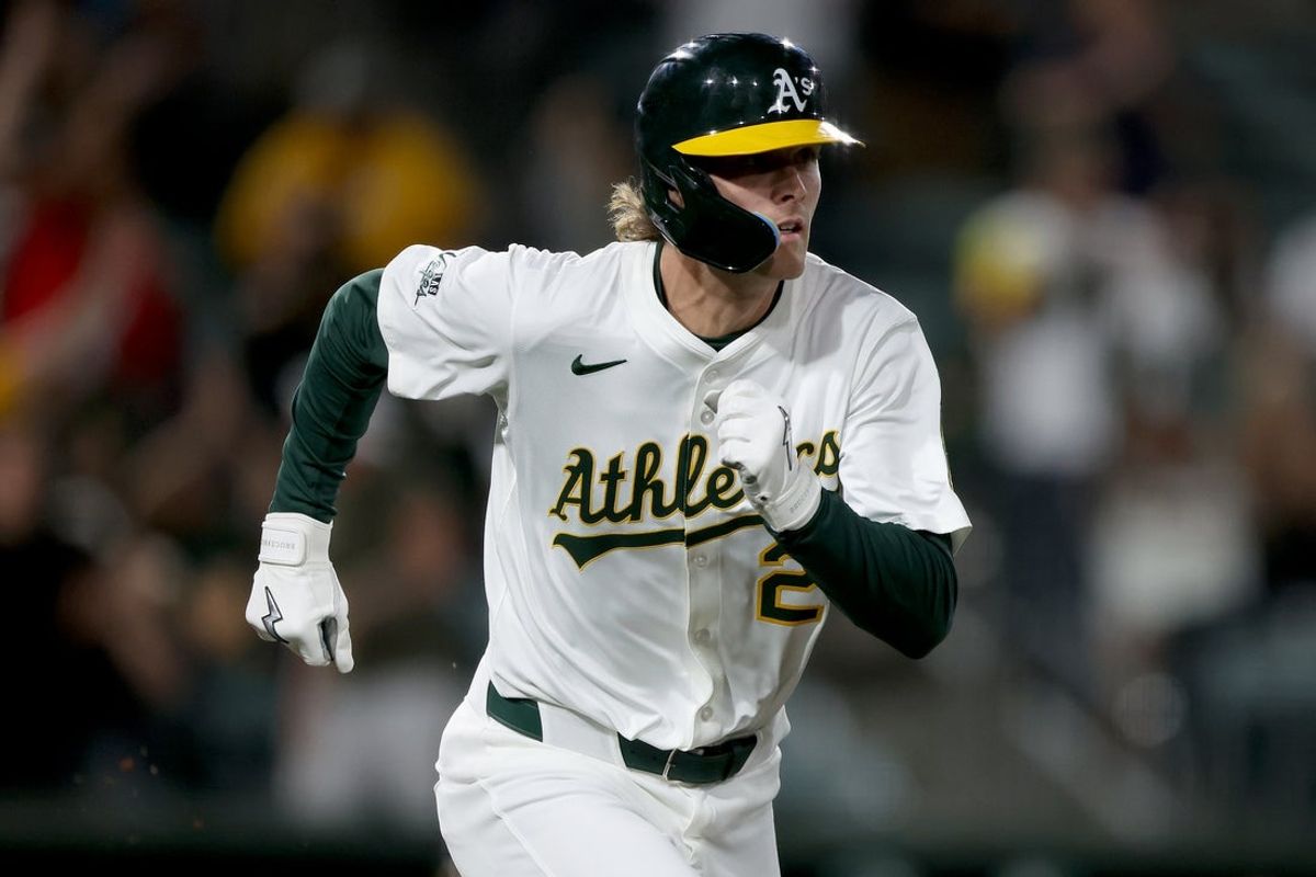 May 23, 2025; West Sacramento, California, USA; Athletics CJ Alexander (26) runs to first after hitting a single against the Philadelphia Phillies during the ninth inning at Sutter Health Park. Mandatory Credit: Dennis Lee-Imagn Images