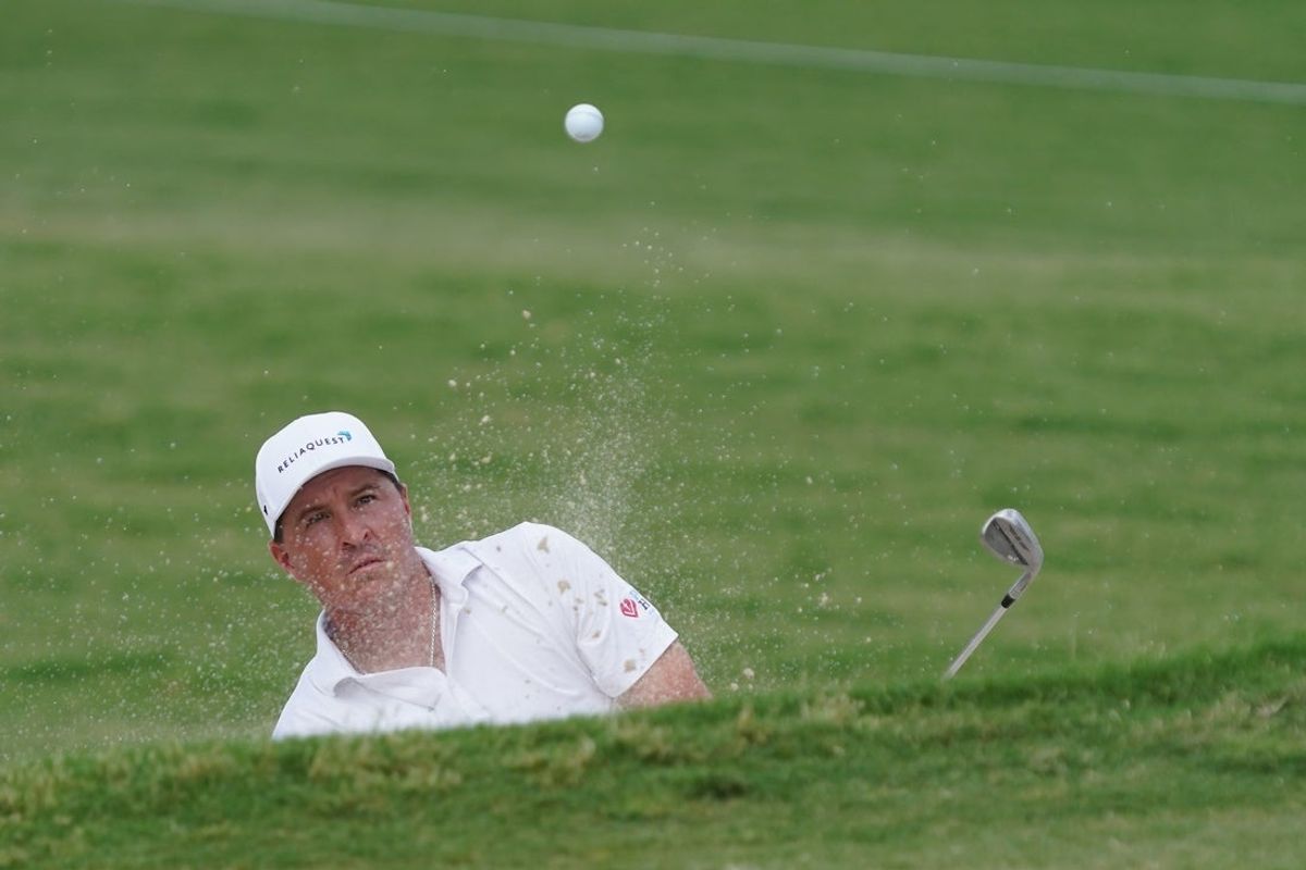 May 24, 2025; Fort Worth, Texas, USA; Kevin Roy plays a shot from a bunker on the 11th hole during the third round of the Charles Schwab Challenge golf tournament. Mandatory Credit: Raymond Carlin III-Imagn Images