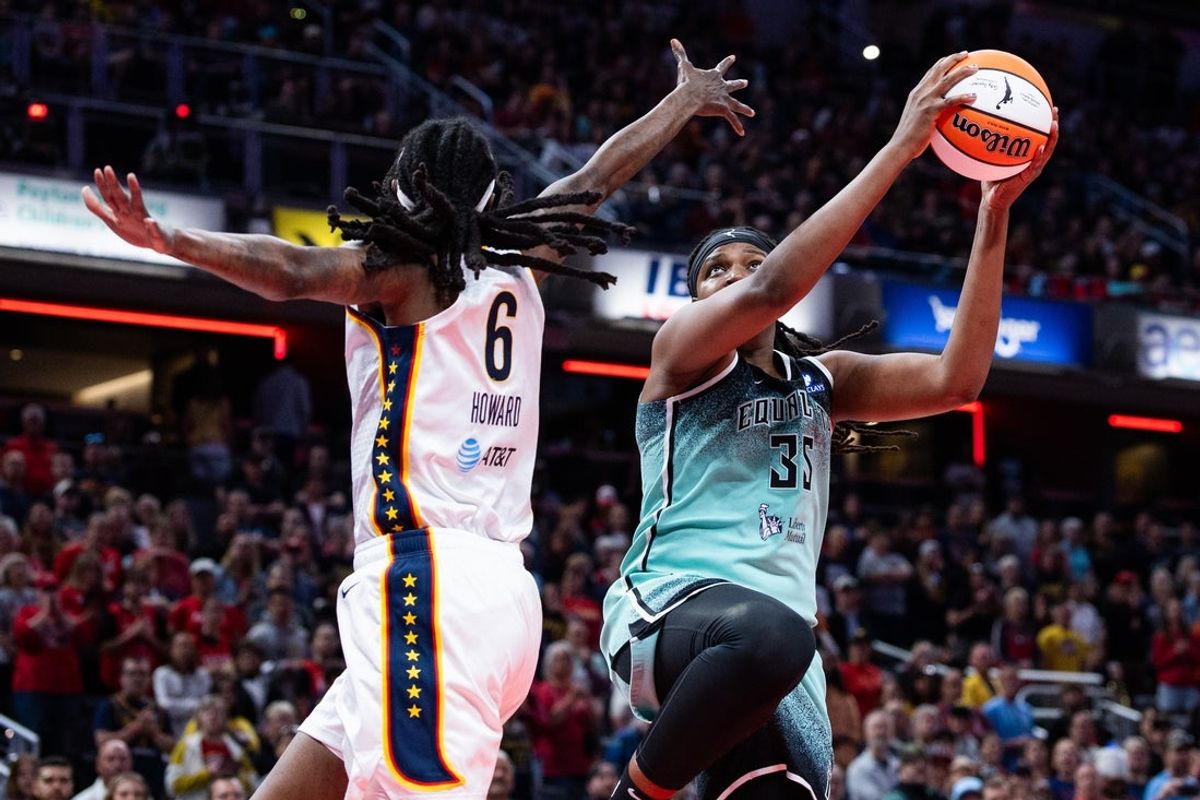 May 24, 2025; Indianapolis, Indiana, USA; New York Liberty center Jonquel Jones (35) shoots the ball while Indiana Fever forward Natasha Howard (6) defends in the first half at Gainbridge Fieldhouse. Mandatory Credit: Trevor Ruszkowski-Imagn Images