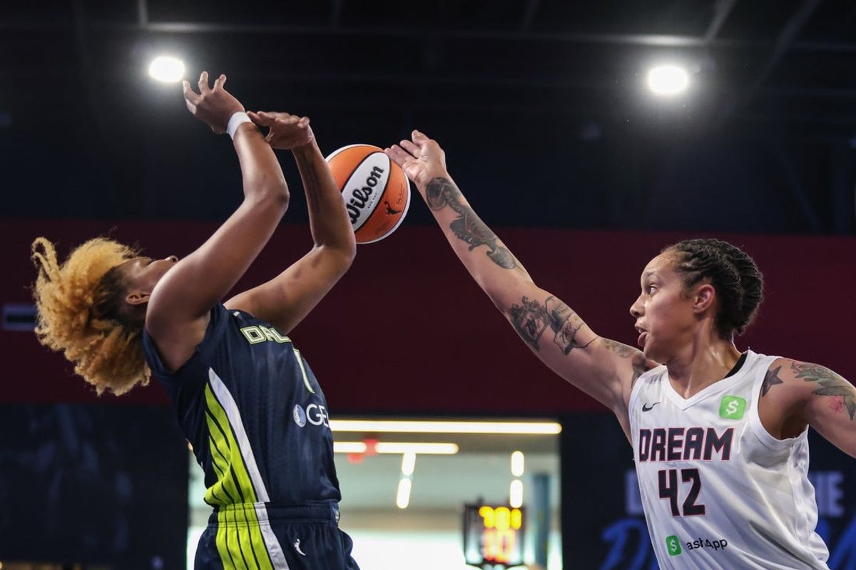 May 24, 2025; College Park, Georgia, USA;  Atlanta Dream center Brittney Griner (42) knocks the ball loose against Dallas Wings forward NaLyssa Smith (1) during the first quarter at Gateway Center Arena at College Park. Mandatory Credit: Jordan Godfree-Imagn Images