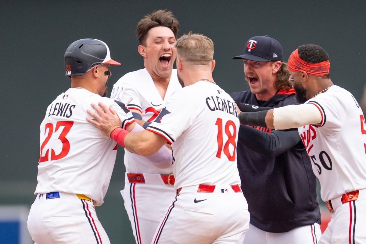 May 24, 2025; Minneapolis, Minnesota, USA; Minnesota Twins shortstop Brooks Lee (2) is congratulated by teammates after hitting the game winning single against the Kansas City Royals at Target Field. Mandatory Credit: Matt Blewett-Imagn Images