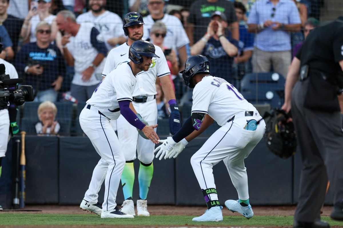 May 24, 2025; Tampa, Florida, USA; Tampa Bay Rays third baseman Junior Caminero (13) celebrates with Tampa Bay Rays second base Brandon Lowe (8) after hitting a three run home run against the Toronto Blue Jays in the first inning at George M. Steinbrenner Field. Mandatory Credit: Nathan Ray Seebeck-Imagn Images