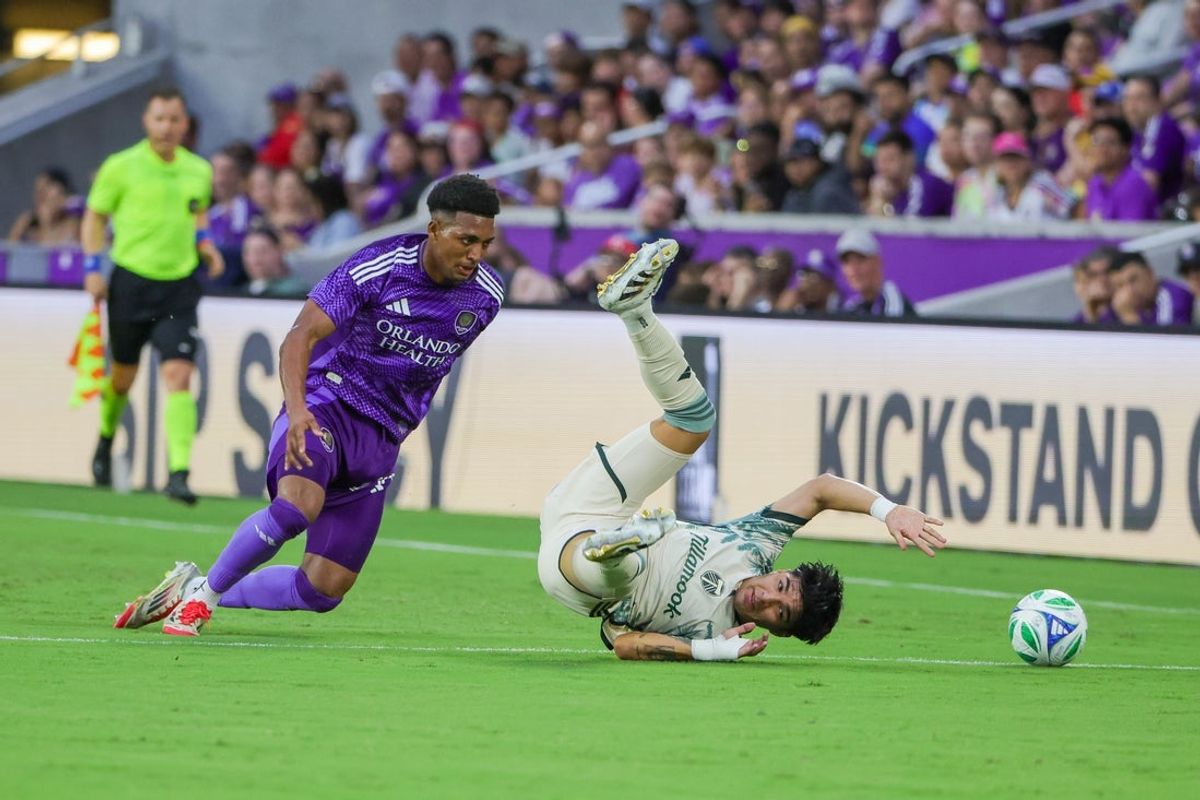 May 24, 2025; Orlando, Florida, USA; Portland Timbers defender Omir Fernandez (22) battles for the ball against Orlando City defender Alex Freeman (30) during the first half at Inter&Co Stadium. Mandatory Credit: Mike Watters-Imagn Images