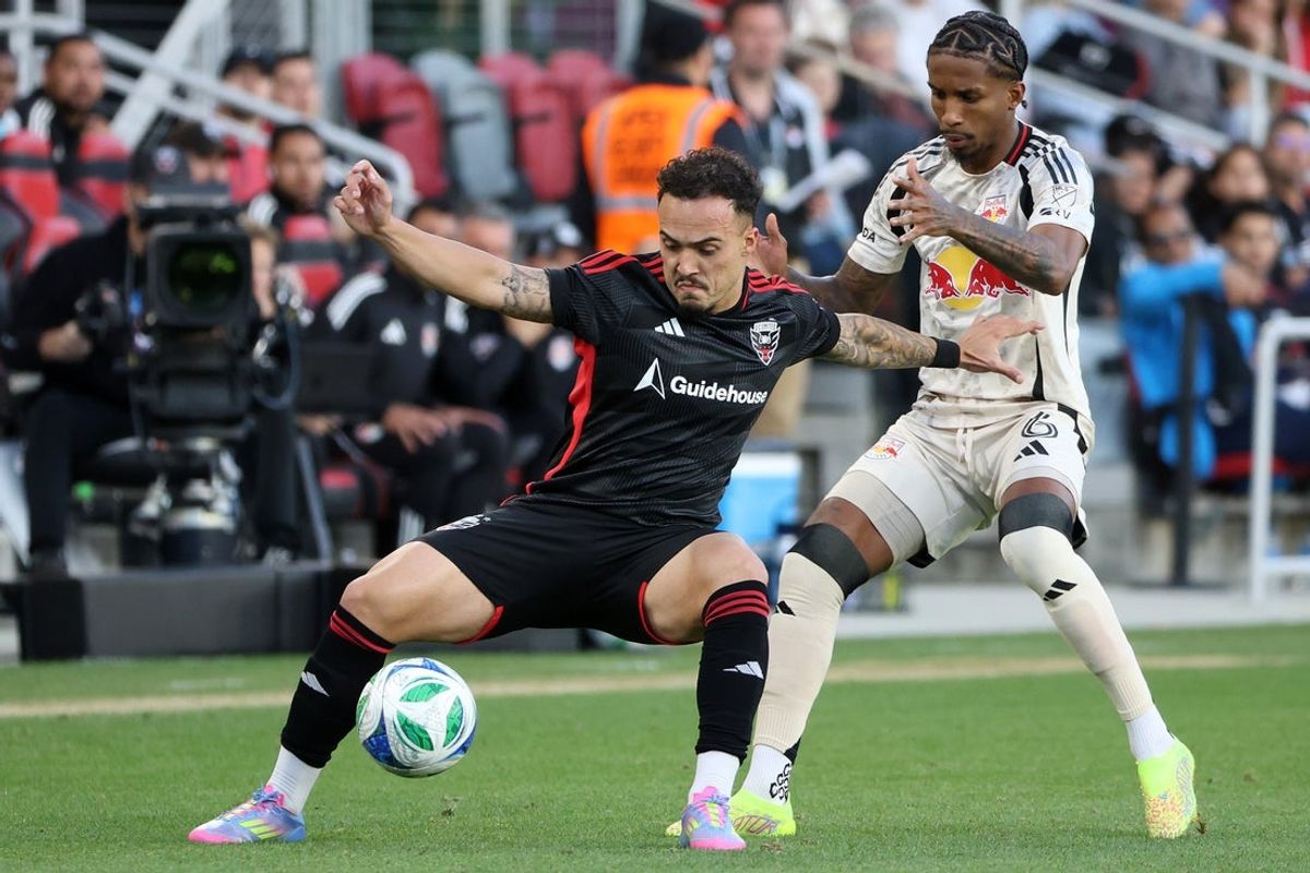 May 24, 2025; Washington, District of Columbia, USA; D.C. United forward Joao Peglow (7) controls the ball against New York Red Bulls defender Kyle Duncan (6) during the first half at Audi Field. Mandatory Credit: Daniel Kucin Jr.-Imagn Images