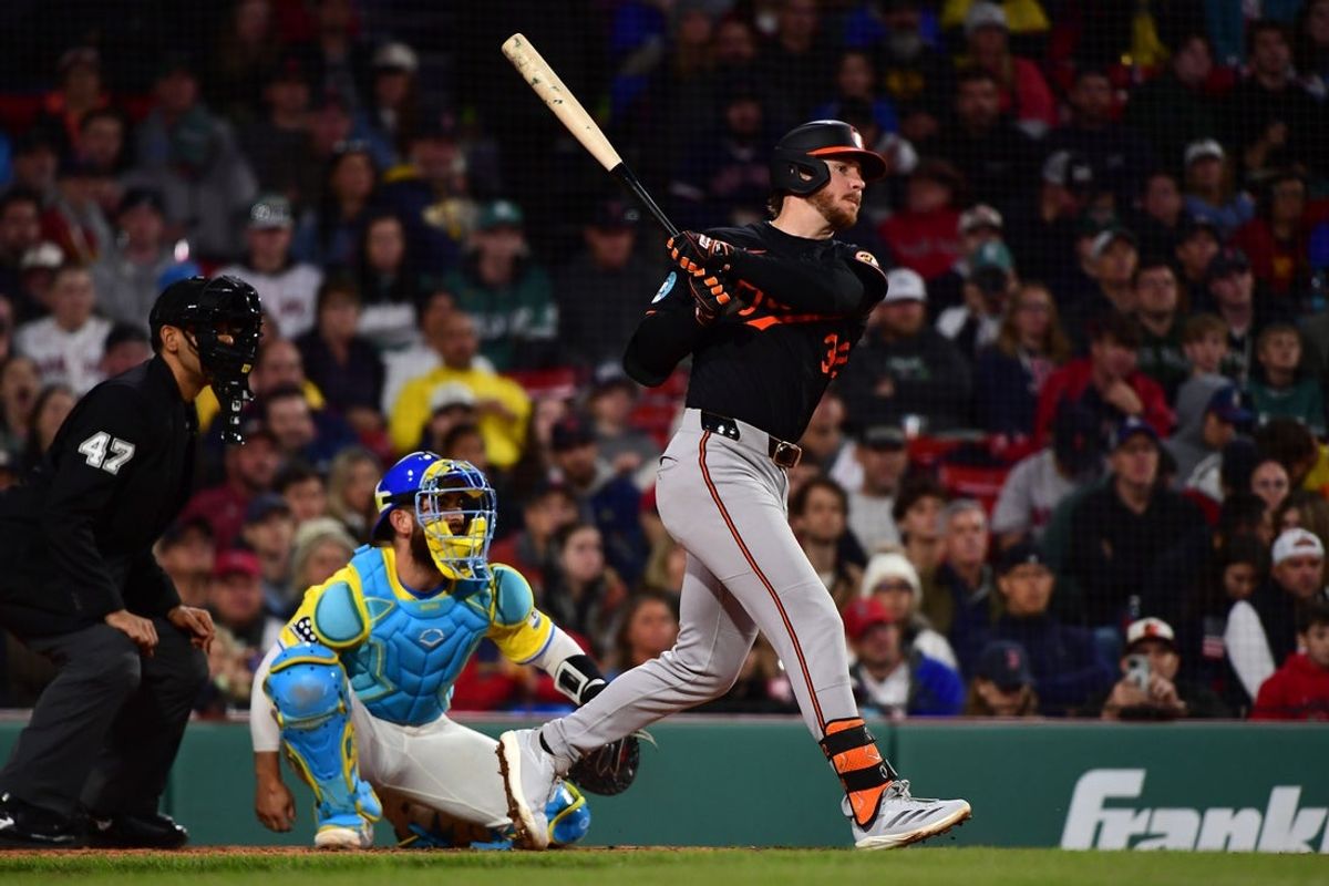 May 24, 2025; Boston, Massachusetts, USA;  Baltimore Orioles right fielder Ryan O'Hearn (32) hits an RBI single during the eighth inning against the Boston Red Sox at Fenway Park. Mandatory Credit: Bob DeChiara-Imagn Images