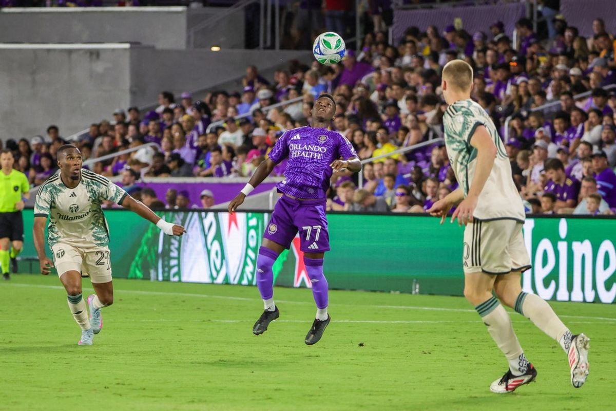 May 24, 2025; Orlando, Florida, USA; Orlando City forward Iván Angulo (77) handles the ball in front of Portland Timbers defender Juan David Mosquera (29) during the second half at Inter&Co Stadium. Mandatory Credit: Mike Watters-Imagn Images