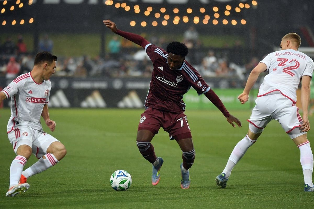 May 24, 2025; Commerce City, Colorado, USA; Colorado Rapids forward Darren Yapi (77) handles the ball against St. Louis City defender Timo Baumgartl (32) during the first half at Dick's Sporting Goods Park. Mandatory Credit: Christopher Hanewinckel-Imagn Images