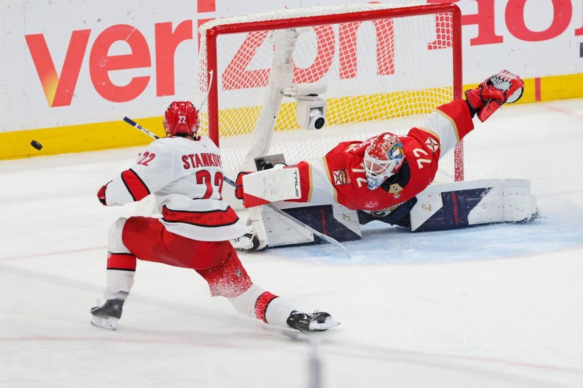 May 24, 2025; Sunrise, Florida, USA; Carolina Hurricanes center Logan Stankoven (22) takes a shot on goal as Florida Panthers goaltender Sergei Bobrovsky (72) makes a save during the second period in game three of the Eastern Conference Final of the 2025 Stanley Cup Playoffs at Amerant Bank Arena. Mandatory Credit: Sam Navarro-Imagn Images