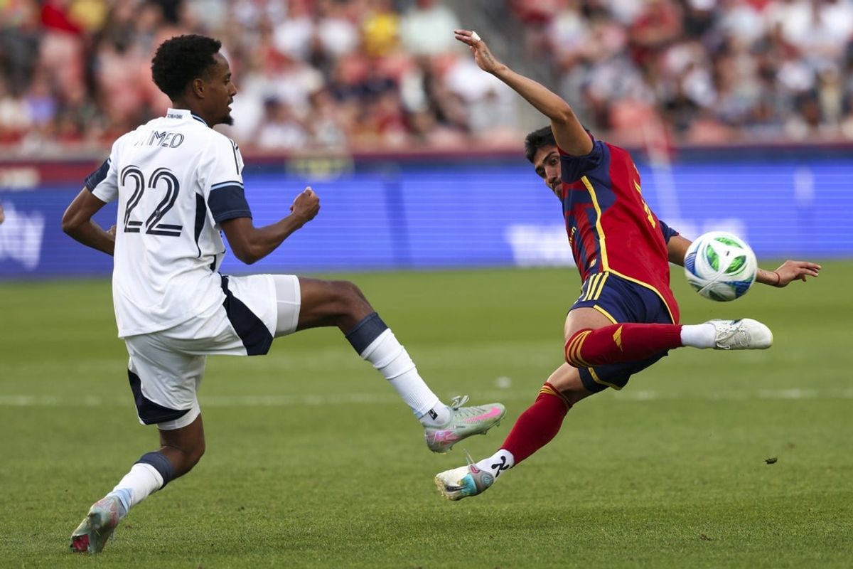 May 24, 2025; Sandy, Utah, USA; Vancouver Whitecaps forward Ali Ahmed (22) and Real Salt Lake midfielder Pablo Ruiz (7) play for the ball during the first half at America First Field. Mandatory Credit: Rob Gray-Imagn Images