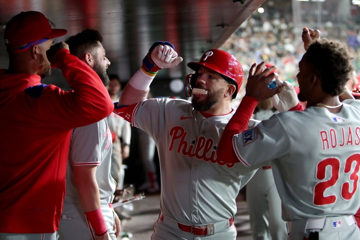 May 24, 2025; West Sacramento, California, USA; Philadelphia Phillies designated hitter Kyle Schwarber (12) is congratulated by teammates in the dugout after hitting a solo home run against the Athletics during the sixth inning at Sutter Health Park. Mandatory Credit: Dennis Lee-Imagn Images