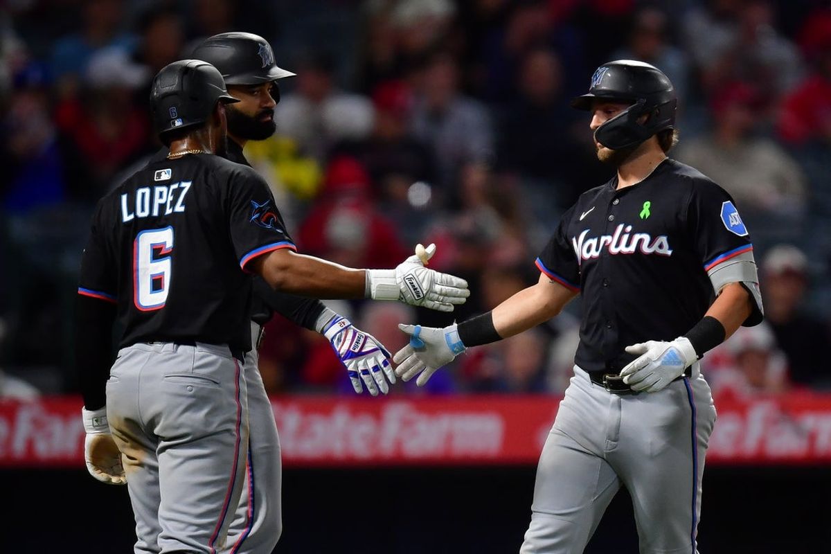 May 24, 2025; Anaheim, California, USA; Miami Marlins third baseman Connor Norby (1) is greeted by shortstop Otto Lopez (6) after hitting a three run home run against the Los Angeles Angels during the seventh inning at Angel Stadium. Mandatory Credit: Gary A. Vasquez-Imagn Images